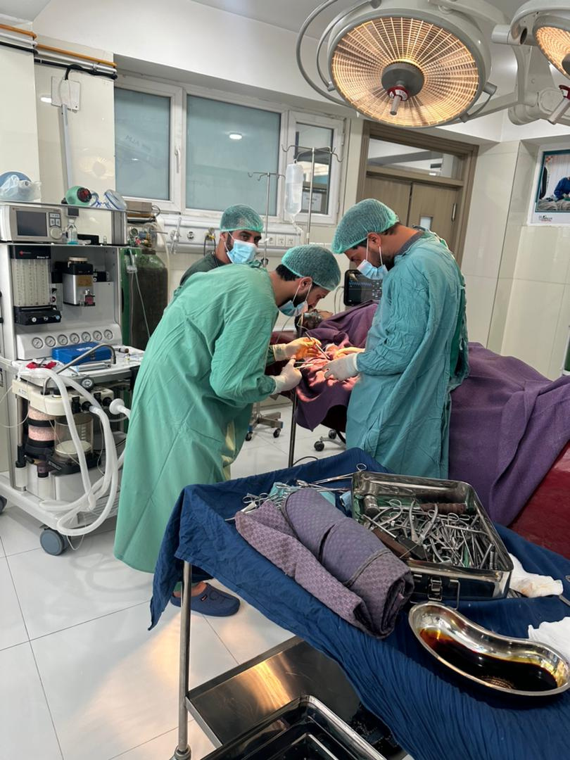 a group of surgeons working on a patient in an operating room