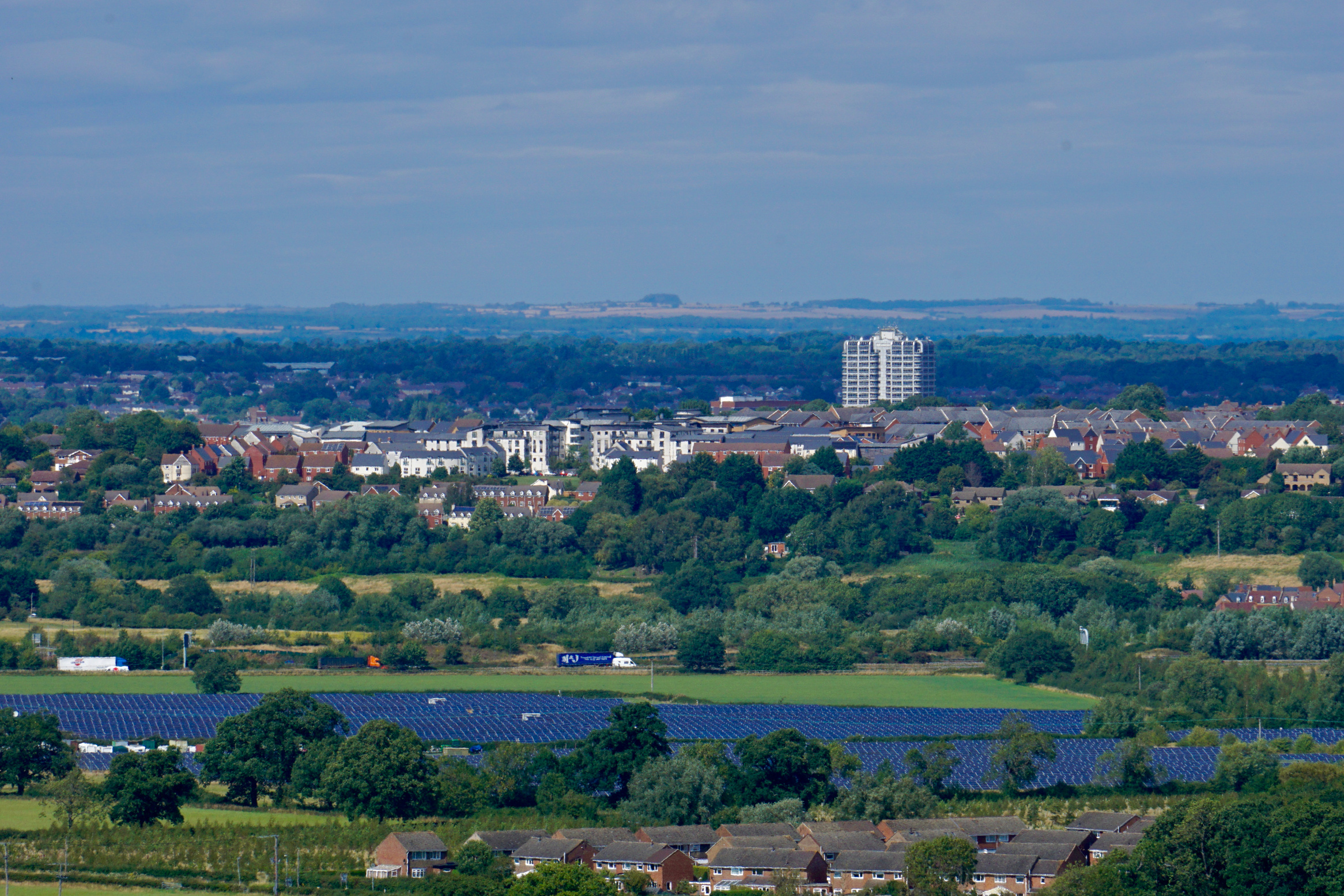 a view of a small English town from the top of a hill