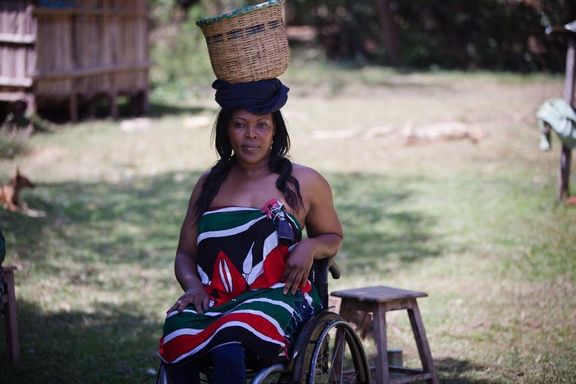 Anne Wafula Strike posing for a photo in a Kenyan outfit.