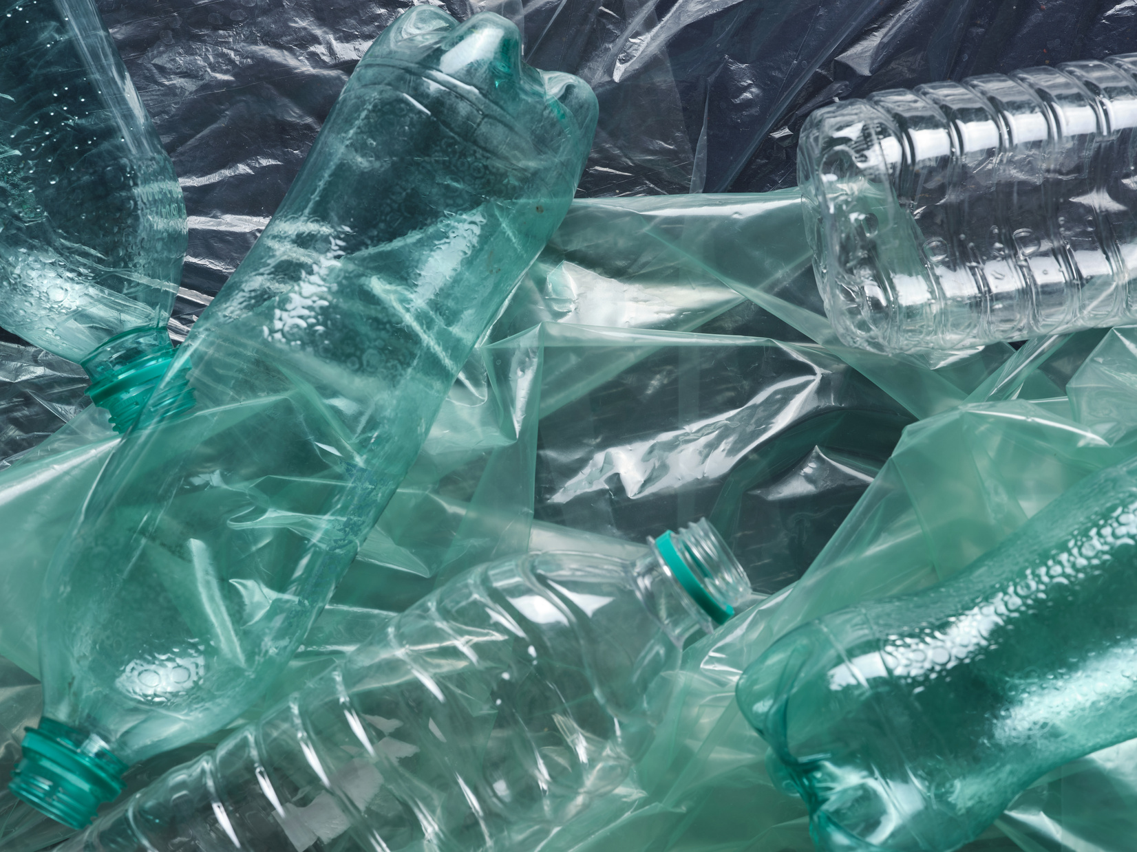 a pile of green plastic bottles on top of each other
