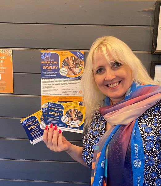 a woman smiling holding rotary leaflets