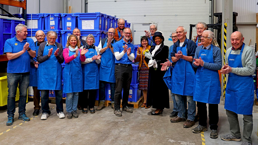 Aquabox volunteers stand together applauding