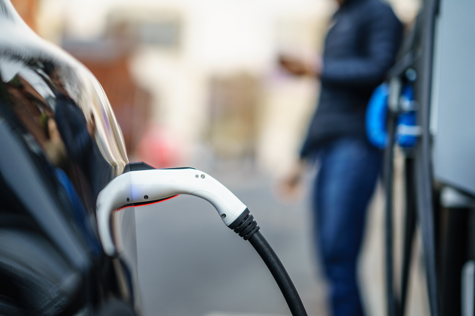 a person is charging an electric car on the street