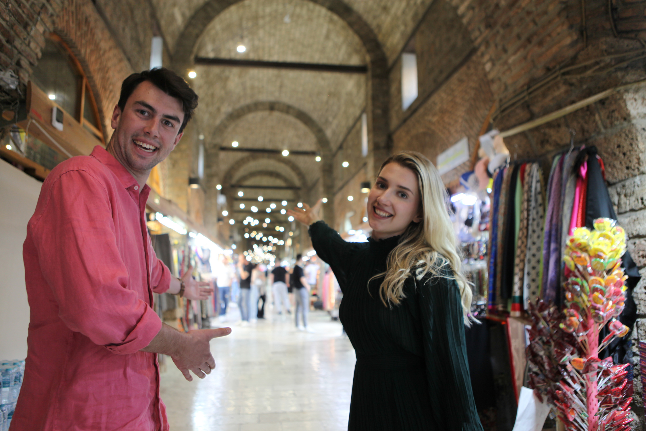 Two people standing in an indoor market