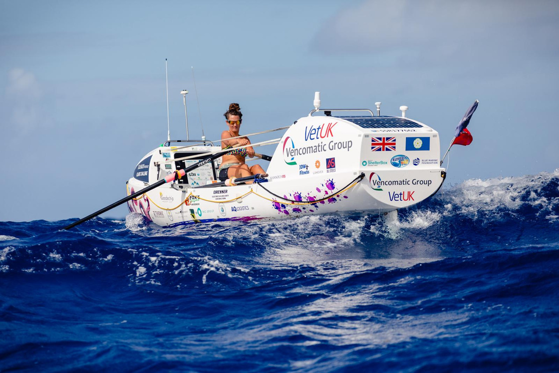 a person is rowing in the ocean in a small boat