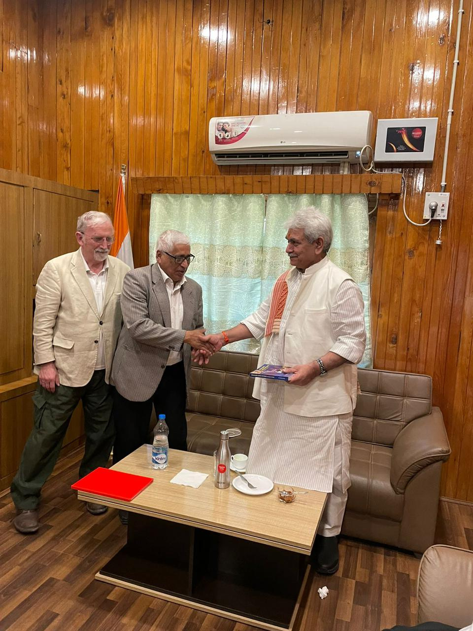 Sauman Ray and David Johnson shaking hands with the Lieutenant Governor of Ladakh