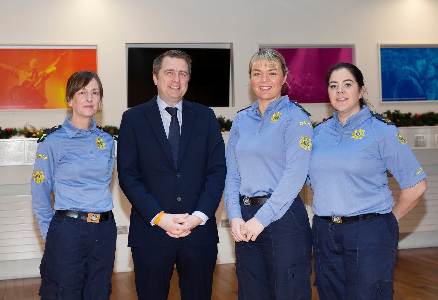 Three road safety officers and someone in a suit standing next to each other.