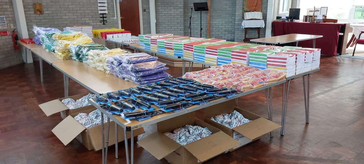 a table filled with boxes of books and other items