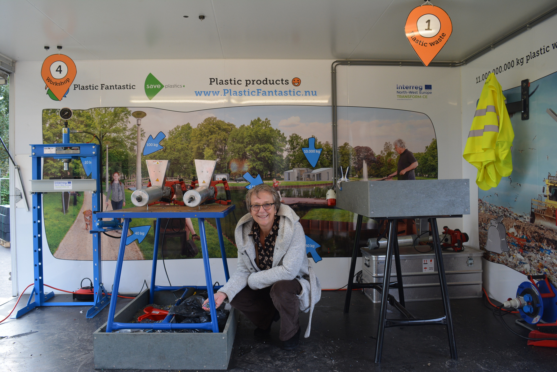 Rebecca Siebinga kneeling in mobile plastic recyle lab