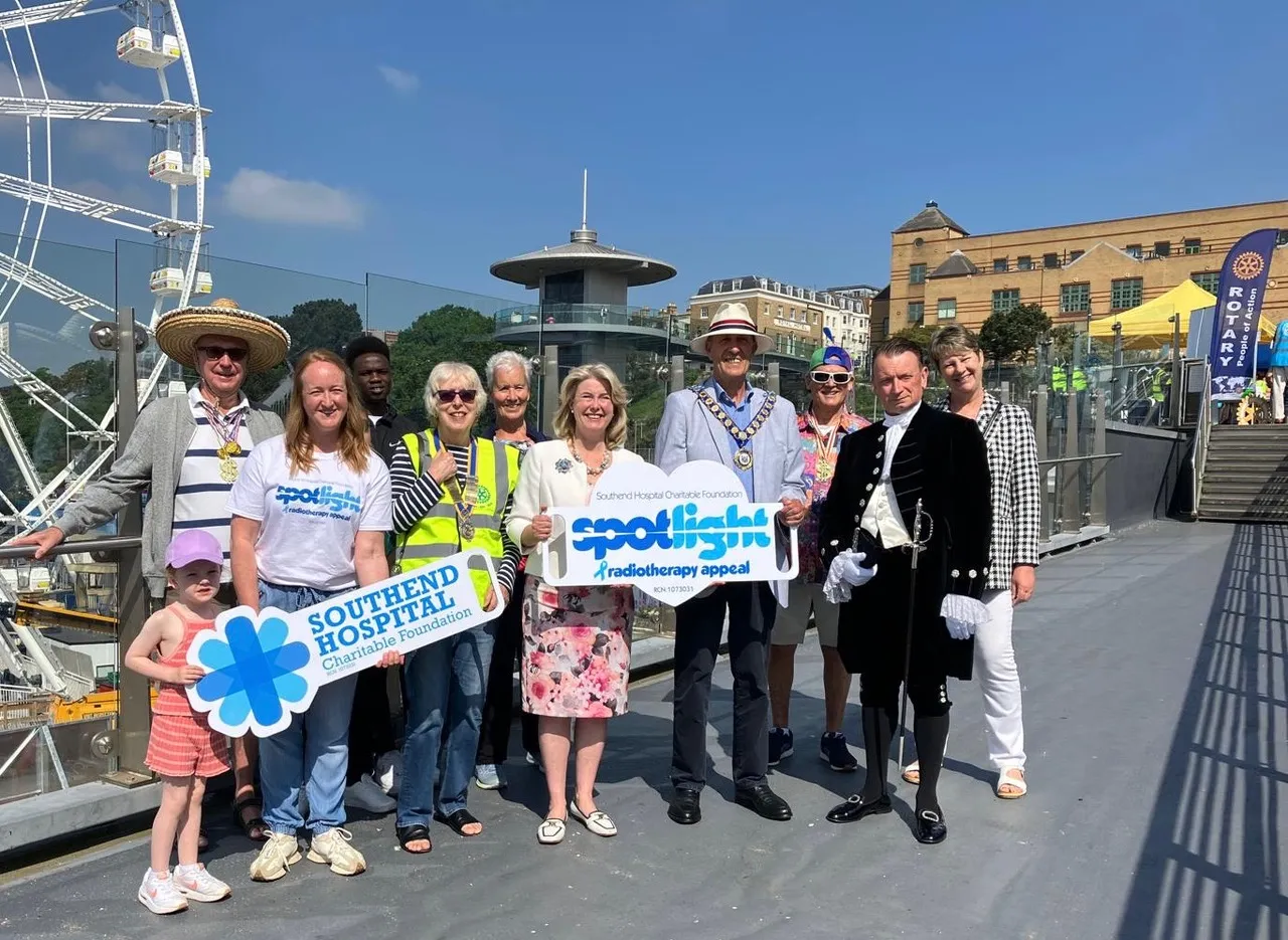 a group of volunteers stand in a city centre with Rotary banners in the background