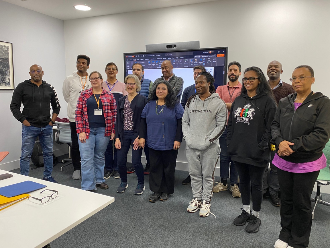 Participants in the 'Launch Reading' event standing in front of a large screen