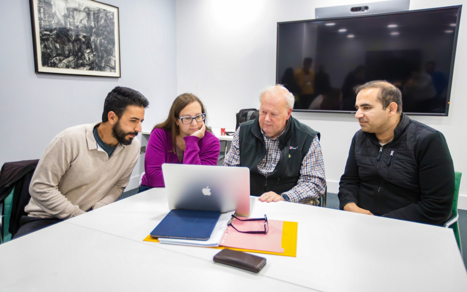 Tutors supporting the 'Launch Reading' event gathered around a computer