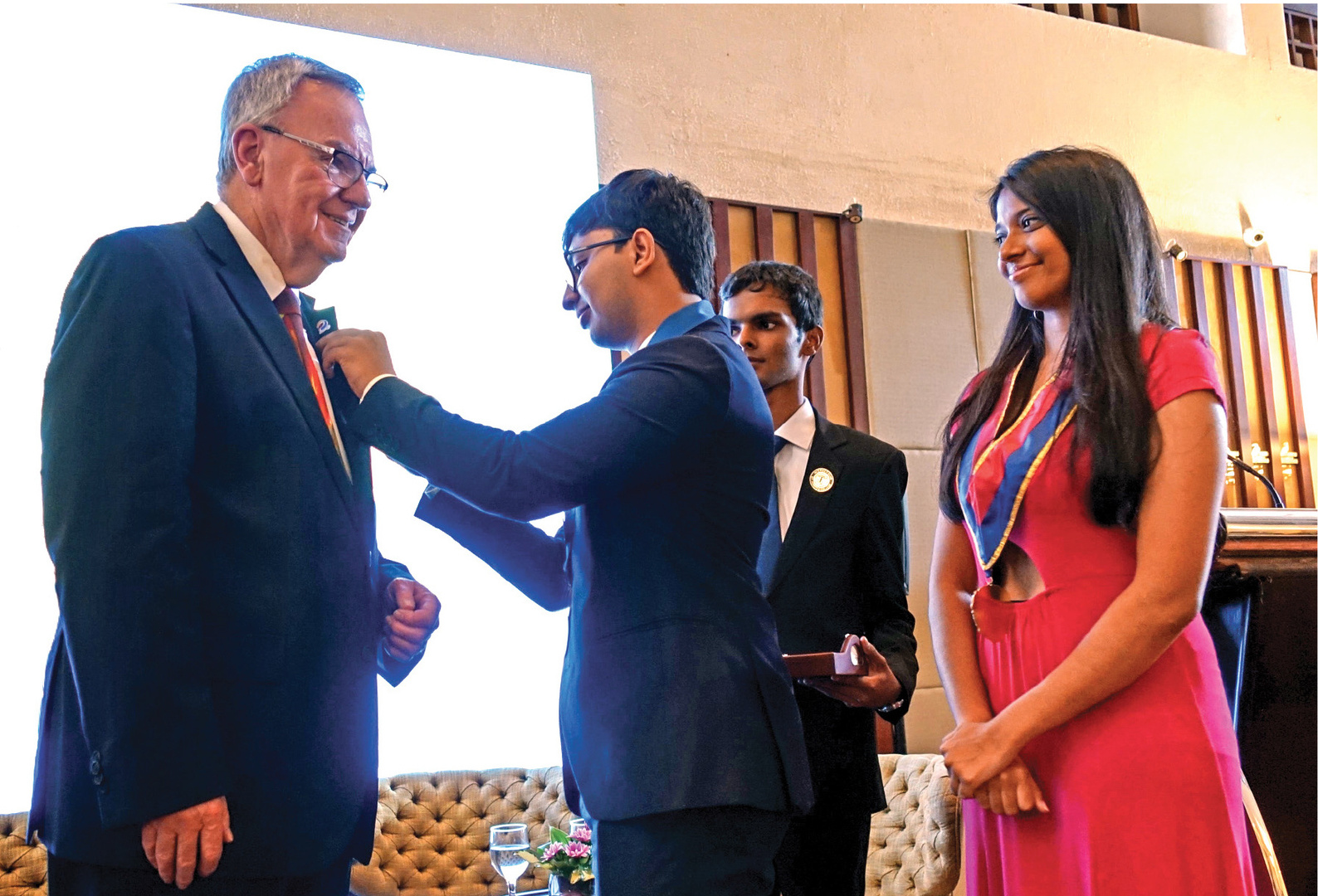 a person in a suit and a person in a pink dress standing next to each other