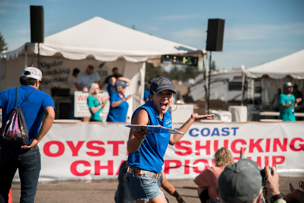 a person in a blue shirt holding a clipboard in front of a crowd