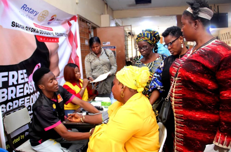 a group of people at a Rotary stall conducting free breast cancer screenings