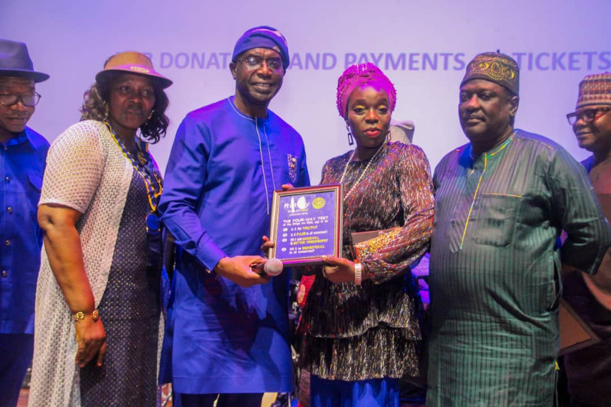 four people posing for a photo with an award plaque at the Alliance Française theater