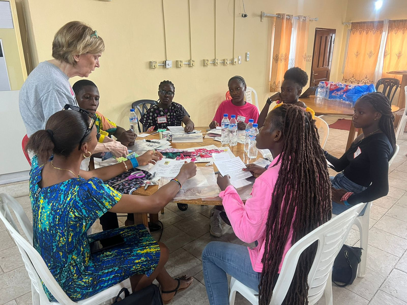 A group of women sit around a table participating in a workshop