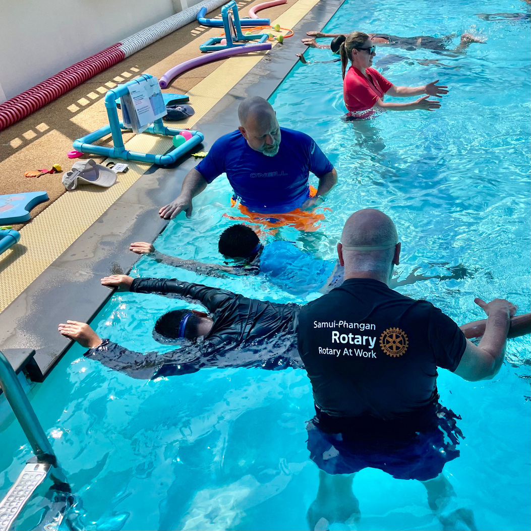 a group of people swimming in a pool