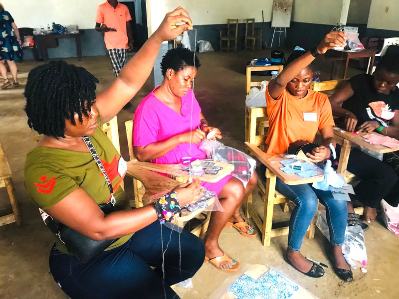 A group of women each undertaking a sewing activity