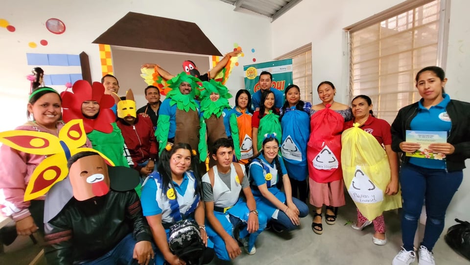 A group of people from Honduras, some dressed as animals and plants, posing for a picture.