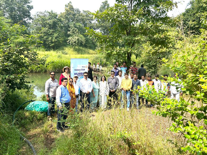 a group of people standing in front of a river