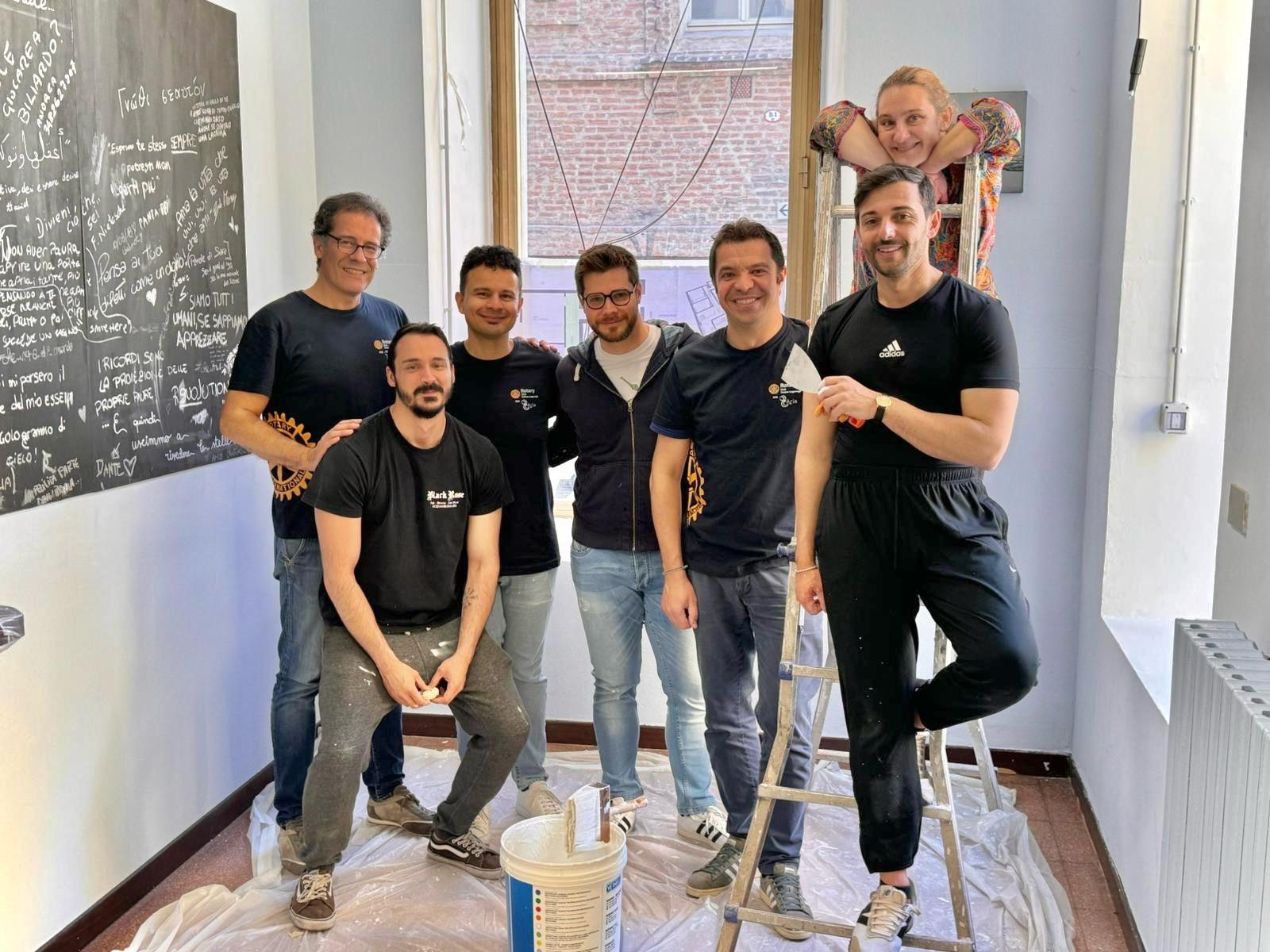 a group posing for a photo in front of a blackboard