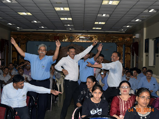 a group of people in a room with their hands in the air