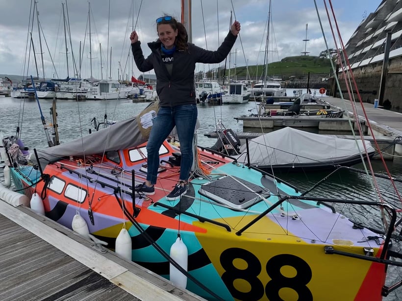 a person standing on top of a colorful boat