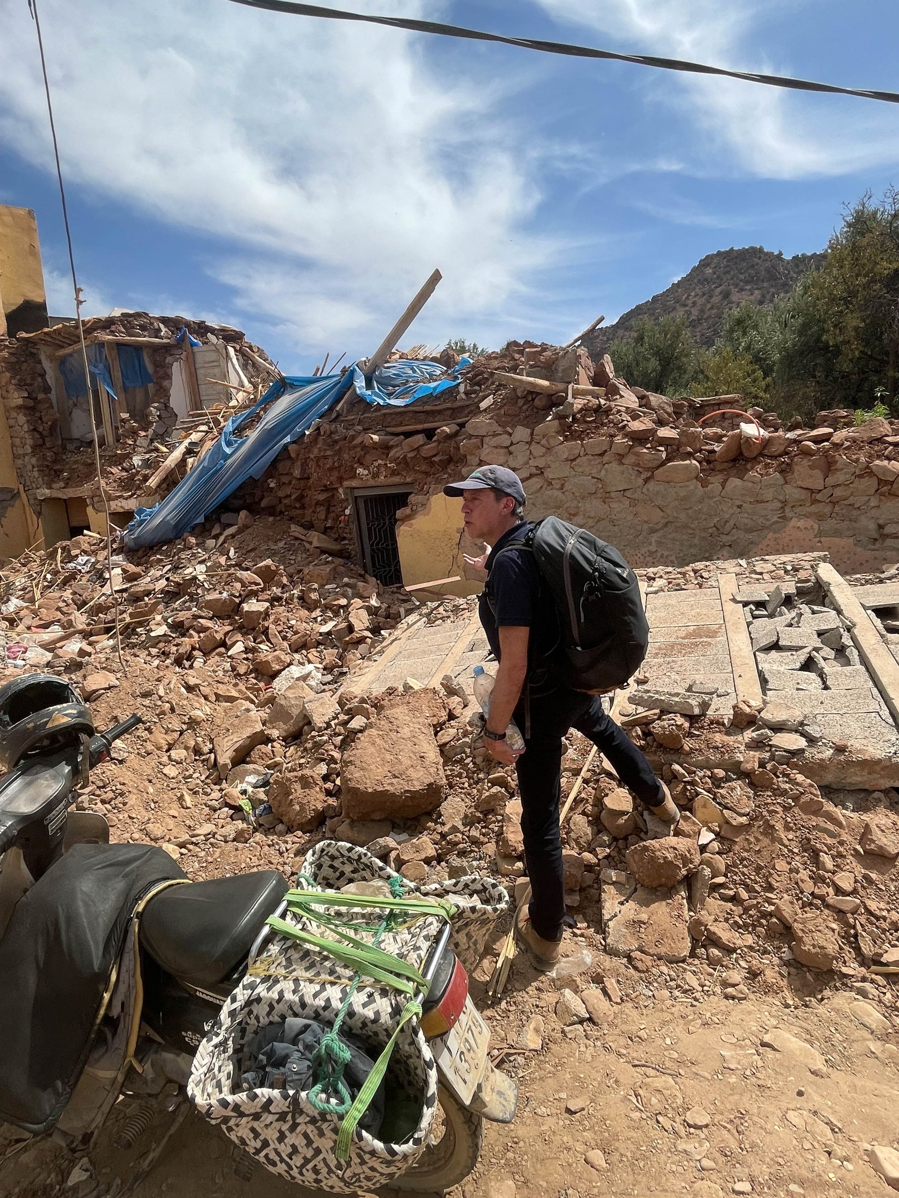 a person standing in front of a pile of rubble