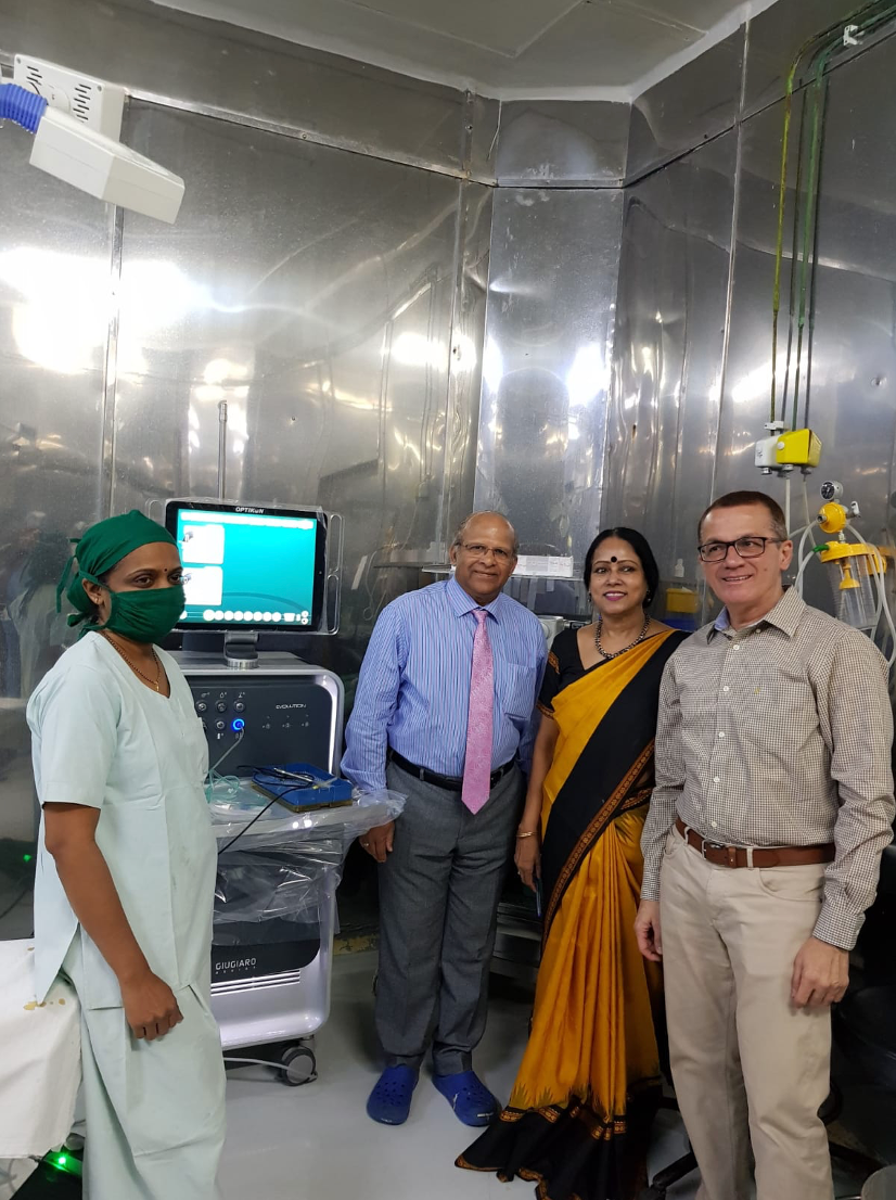 a group of people standing in front of a medical machine