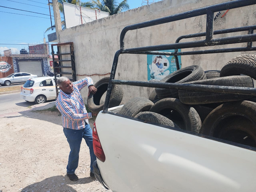 a man unloads tyres from a truck