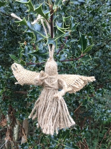 A Christmas angel sent by Rotary GB&I to young people in Ukraine that is hanging on a tree.