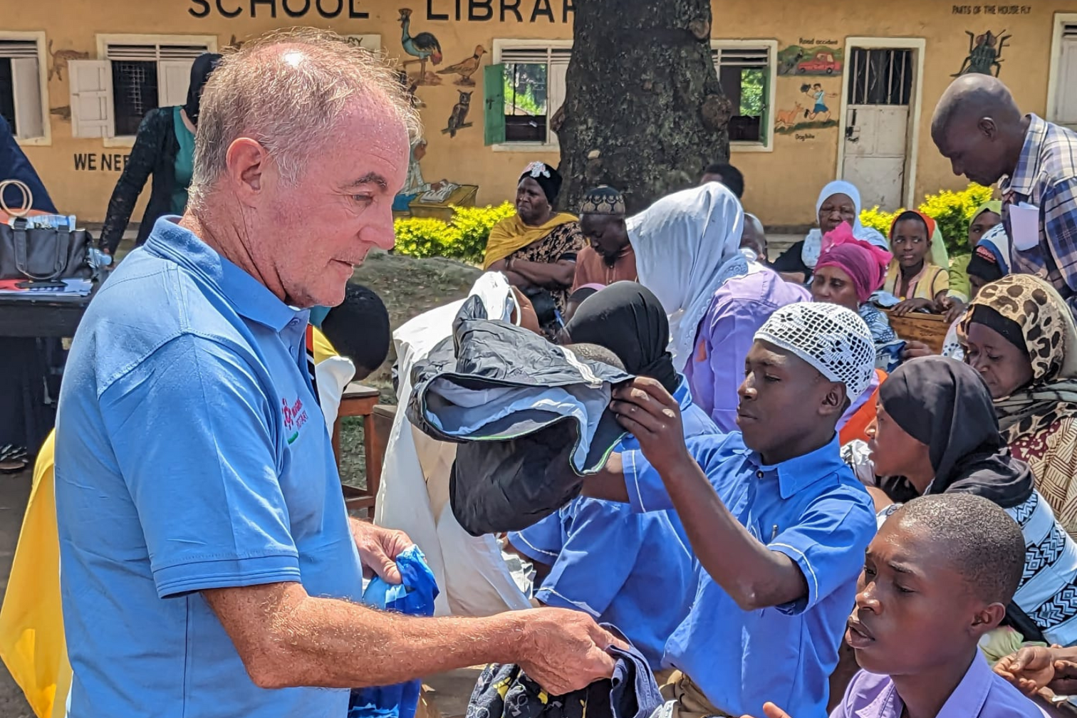 Nick Bell talking to a group of children in Uganda.