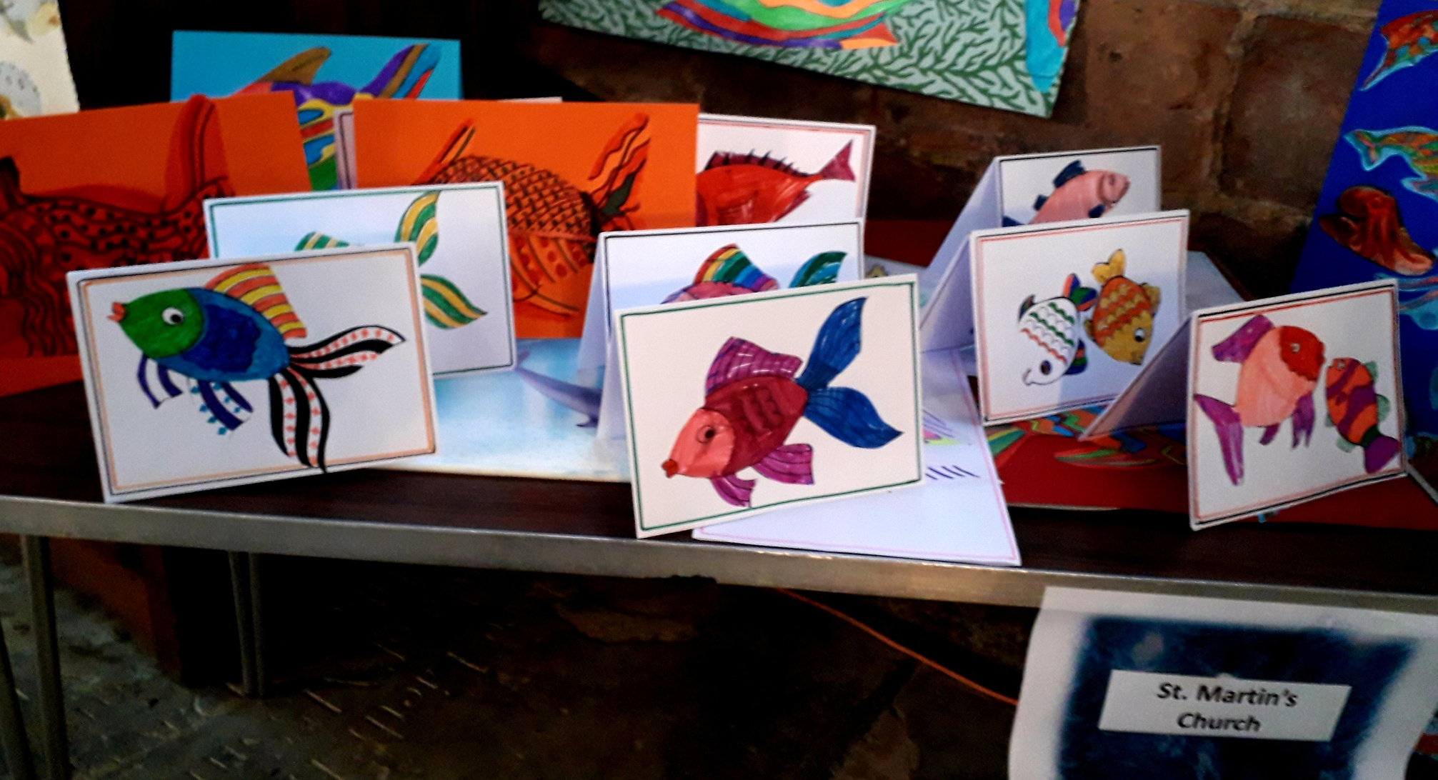 several colorful cards with pictures of fish are displayed on a table